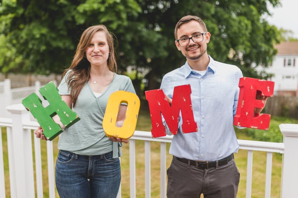 Couple holding colorful letters spelling 